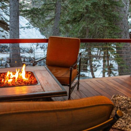 Enjoy the fire, the soothing stream, and the gourmet air of the mountains just outside on one of two private decks.