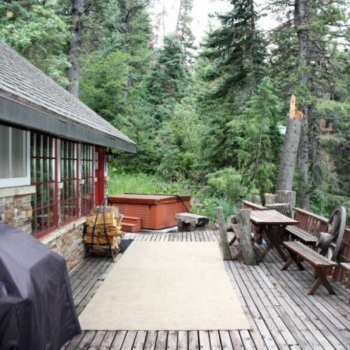 Main deck features propane BBQ, picnic table and benches and access to hot tub under the stars.