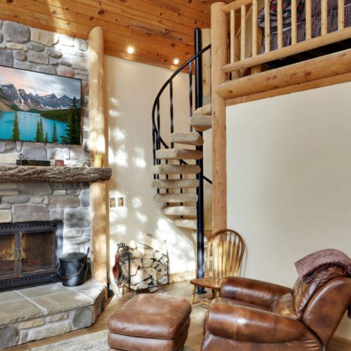 Wood burning fireplace, television and access to loft sleeping area.